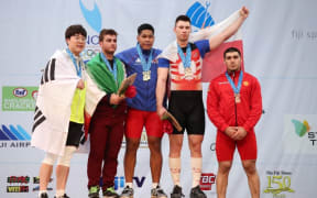 Don Opeloge celebrates won two gold medals at the 2019 Junior World Weightlifting Championships.
