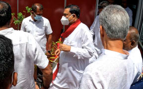 Sri Lanka's former finance minister Basil Rajapaksa gestures after attending his final press conference to inform his resignation as a Member of parliament at Colombo, Sri Lanka.