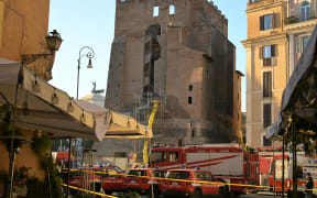 Firefighters work on the site after a part of medieval tower "Torre dei Conti" collapses near the Roman Forum in the historic center of Rome on November 3, 2025.