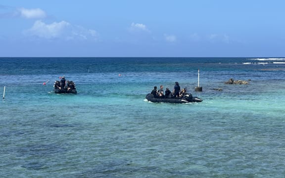 New Zealand navy divers make their through the Ava i Toga opening in the Tafitoala Reef on their way to the wreck of the HMNZS Manawanui.