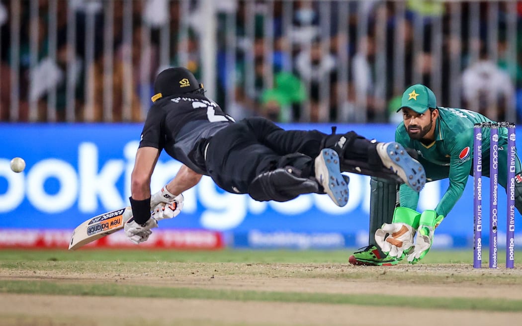 Glenn Phillips from the New Zealand BlackCaps dives to make his ground against Pakistan.