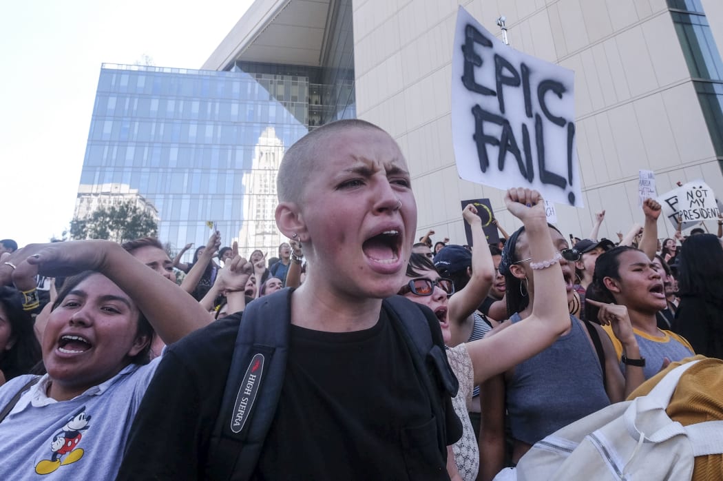 Demonstrators rally outside Los Angeles City Hall to protest Donald Trump winning the White House.