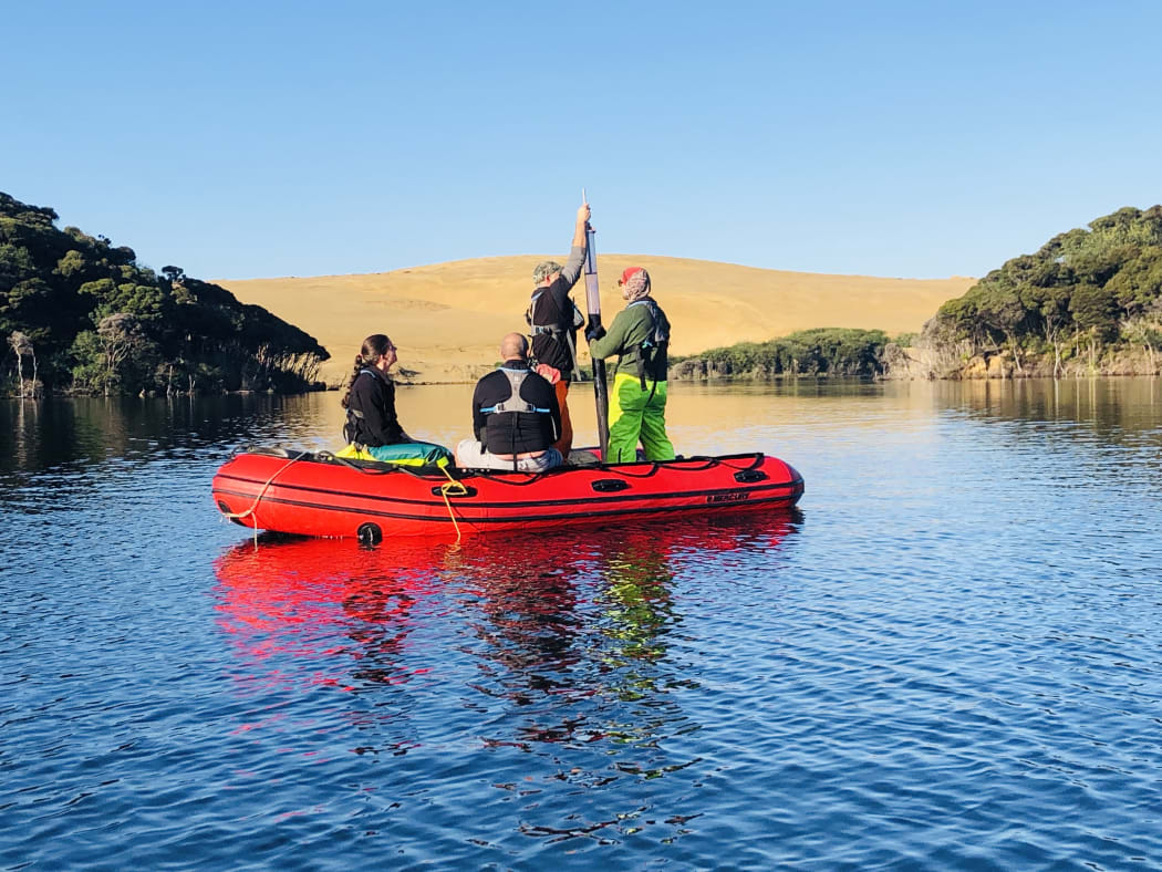 Collecting a sediment core from Lake Wai Raupo in Northland.