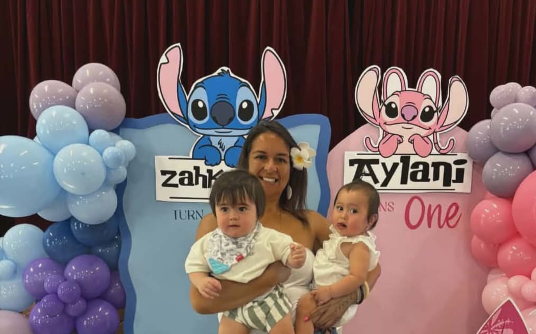 Biddy Tai Ahmu and her twin grandchildren, Aylani and Zahkani.