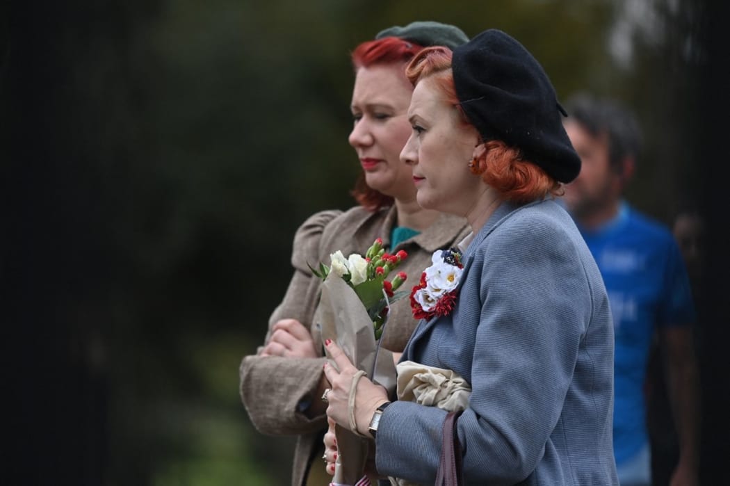 Well-wishers carry floral tributes to Britain's Prince Philip, Duke of Edinburgh, the day after his death at the age of 99, outside Windsor Castle in Windsor, west of London on April 10, 2021.