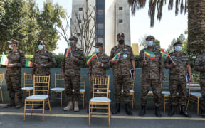 Members of the Ethiopian Army stand holding Ethiopian national flags during an event to honour the national defence forces in Addis Ababa, on November 17, 2020.