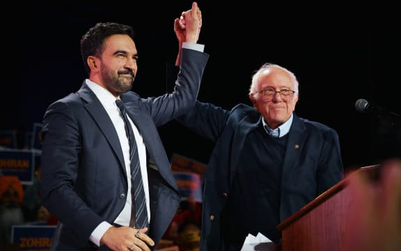 NEW YORK, NEW YORK - OCTOBER 26: New York Mayoral Candidate Zohran Mamdani celebrates with Sen. Bernie Sanders (I-VT) during an election rally with Sanders and U.S. Rep. Alexandria Ocasio-Cortez (D-NY) at Forest Hills Stadium on October 26, 2025 in the Queens borough of New York City. The mayoral election will take place on November 4, 2025.   Andres Kudacki/Getty Images/AFP (Photo by ANDRES KUDACKI / GETTY IMAGES NORTH AMERICA / Getty Images via AFP)