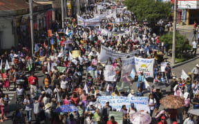 Members of the Peasant Development Committee march to demand the resignation of Guatemalan President Jimmy Morales and the renewal of the mandate of an anti-corruption mission of the UN, in Guatemala City on September 12, 2018.