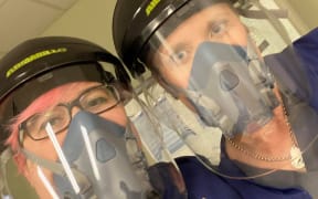 Nurse Abbey Vanderschantz (left) and colleague dressed in PPE