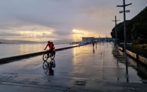 The rain has set in on the Wellington waterfront, as the sun rises and a handful of people exercise