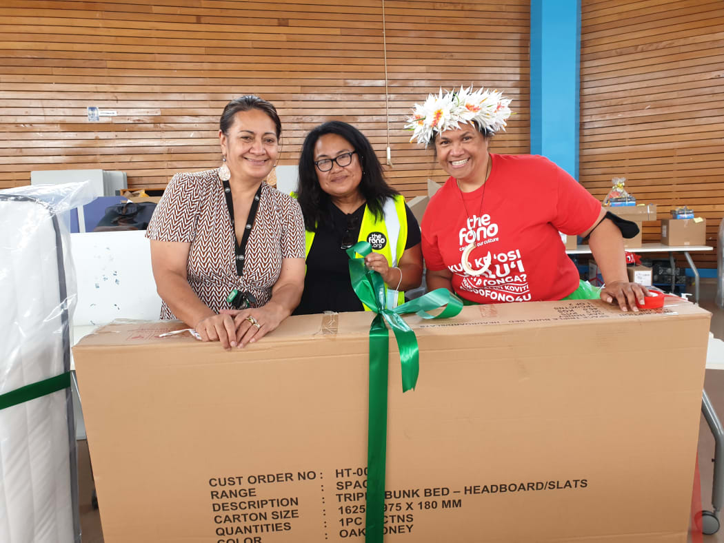 Staff members at The Fono are wrapping a bunk bed for families in need.