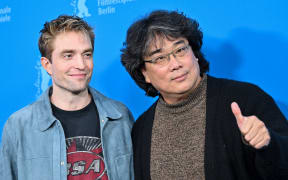 South Korean director Bong Joon Ho (R) and English actor Robert Pattinson pose during a photo call for the film 'Mickey 17' presented as Berlinale Special Gala at the 75th Berlinale, Europe's first major film festival of the year, in Berlin on February 15, 2025. (Photo by Stefanie Loos / AFP)