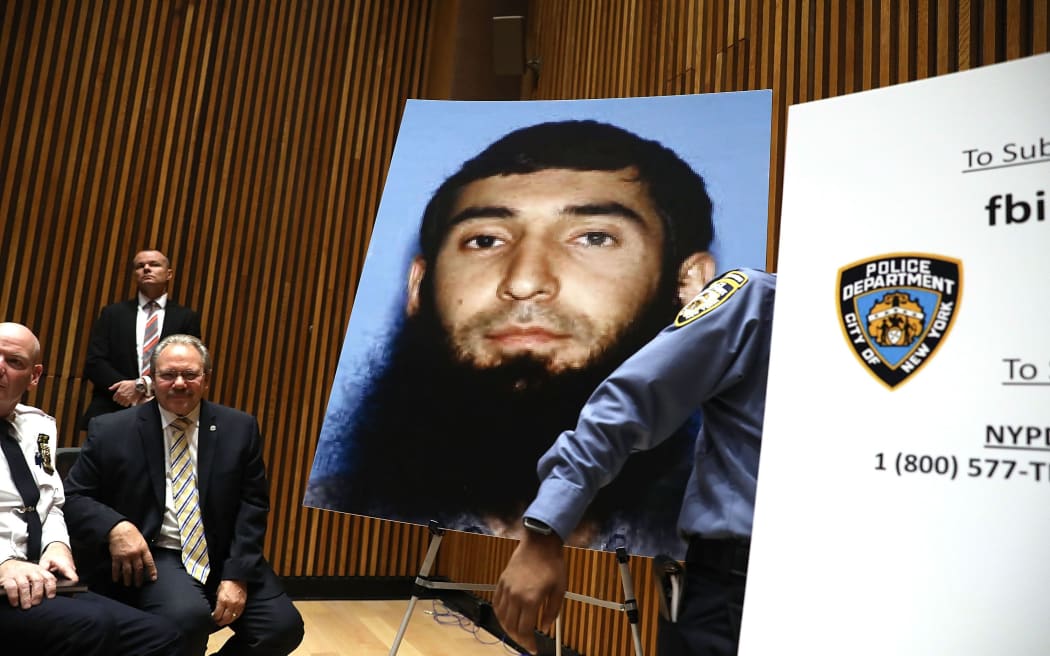 A picture of suspect Sayfullo Saipov is displayed during a news conference about yesterday's attack along a bike path in lower Manhattan.