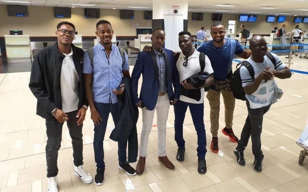 Manus Island refugees waiting to leave Port Moresby's airport, including from left, Mohamed Sanosi and Omar Muhammed Jack.