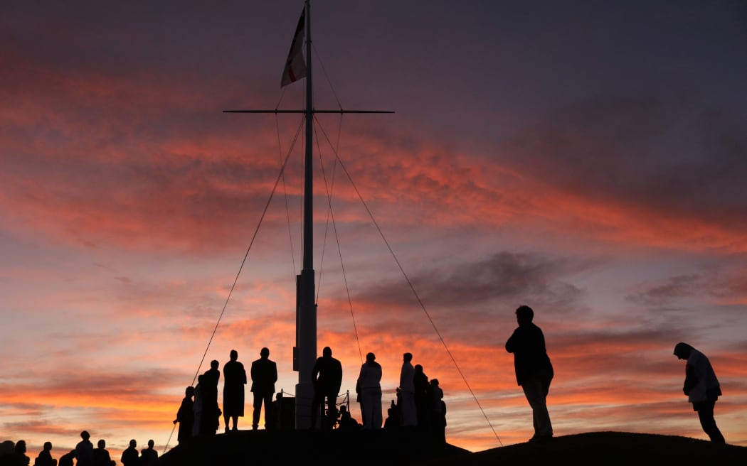 People gather at dawn atop Maiki, or Flagstaff, Hill for the 175th anniversary of the Battle of Kororāreka in 2020.