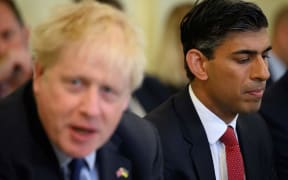 Britain's Chancellor of the Exchequer Rishi Sunak (R) reacts as Britain's Prime Minister Boris Johnson speaks during a Cabinet meeting at 10 Downing Street, in London, on June 7, 2022. - British Prime Minister Boris Johnson survived on June 6 a vote of no confidence from his own Conservative MPs but with his position weakened after a sizeable number refused to back him. The Brexit figurehead called the 211-148 split a "convincing result, a decisive result". (Photo by Leon Neal / various sources / AFP)