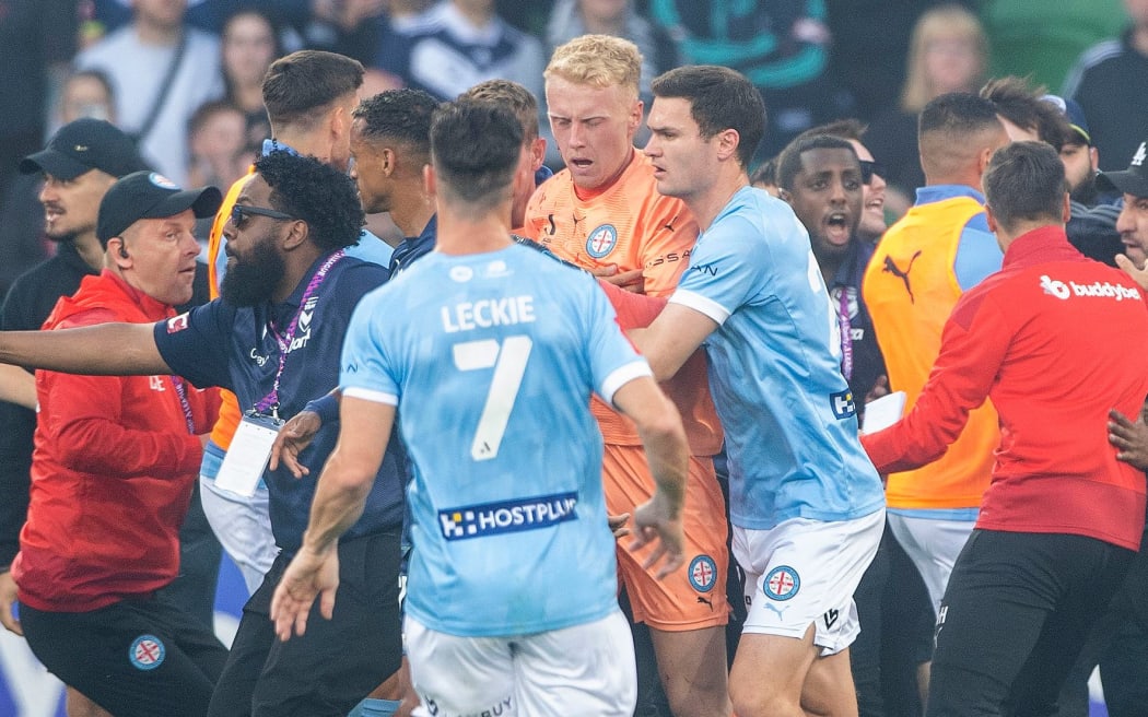 A bleeding Tom Glover of Melbourne City is escorted from the pitch during the A-League Men's soccer match between Melbourne City and the Melbourne Victory at AAMI Park in Melbourne, Saturday, December 17, 2022. (AAP Image/Will Murray / www.photosport.nz