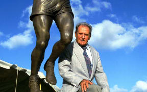 Athletics legend Arthur Lydiard sits atop a statue of him 2001.