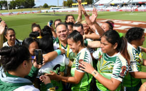 Cook Islands' players celebrate beating England.