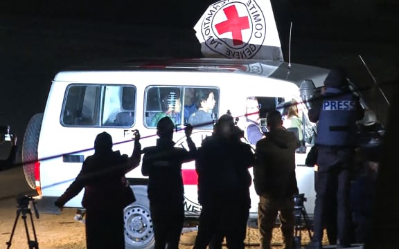 This image grab taken from AFPTV video footage on November 25, 2023 shows an International Red Cross vehicle reportedly carrying hostages released by Hamas driving towards the Rafah border point with Egypt ahead of their transfer to Israel. A group of 13 Israeli and four Thai hostages released by Hamas crossed into Egypt late Saturday, Egyptian state-linked television reported.