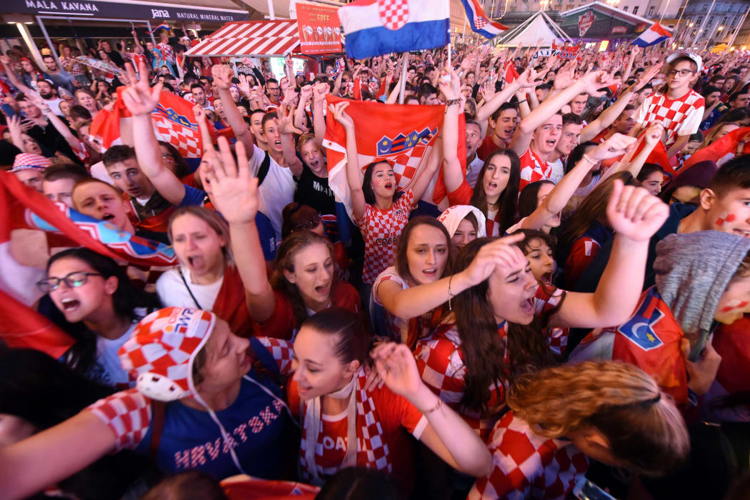 Croatia's supporters react as they watch on a giant screen the Russia 2018 World Cup semi-final football match between Croatia and England, at the main square in Zagreb on July 11, 2018.