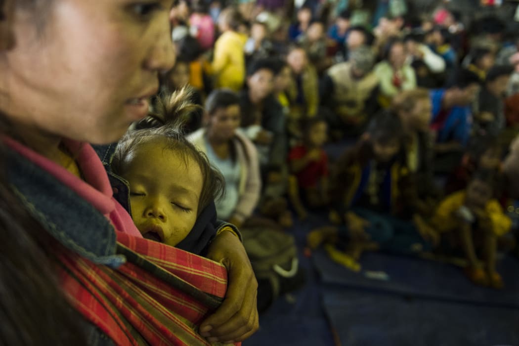 Residents displaced by massive flood waters from the collapsed dam seek shelter in Paksong town in Champasak province on July 25, 2018.