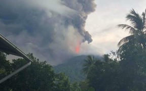 A picture of a flash of lava from the erupting volcano on Manam Island, Papua New Guinea. The island is one of the country's most active volcanoes.