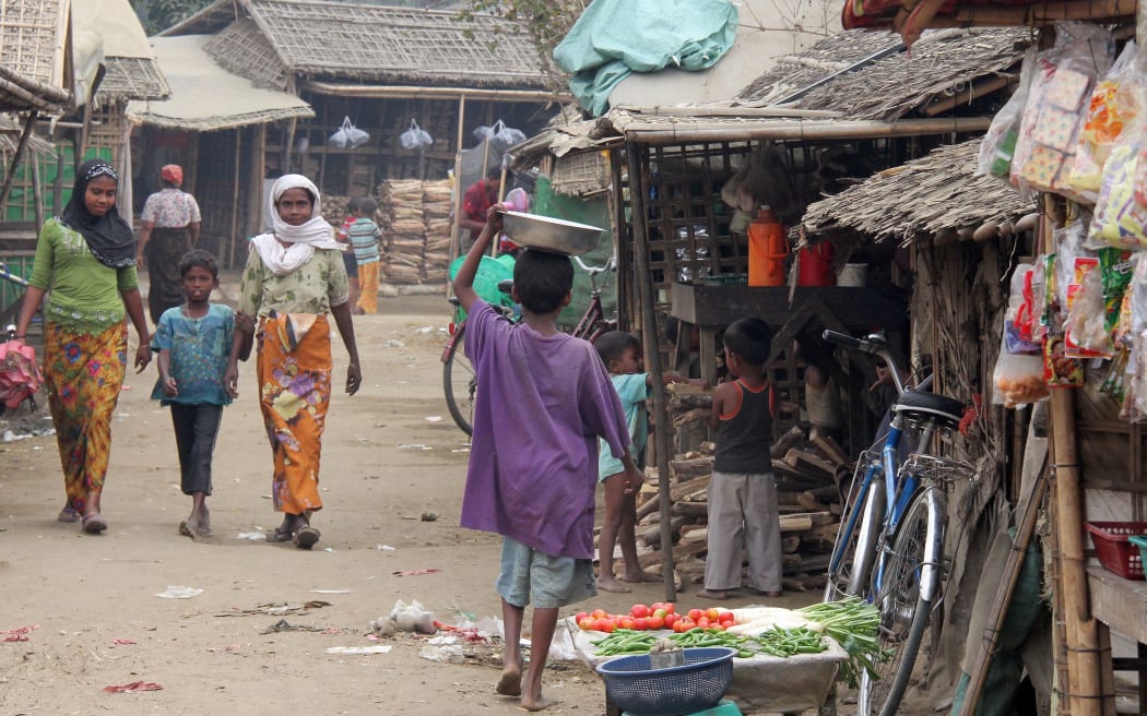 Dusty earth street with pedestrians and makeshift shops