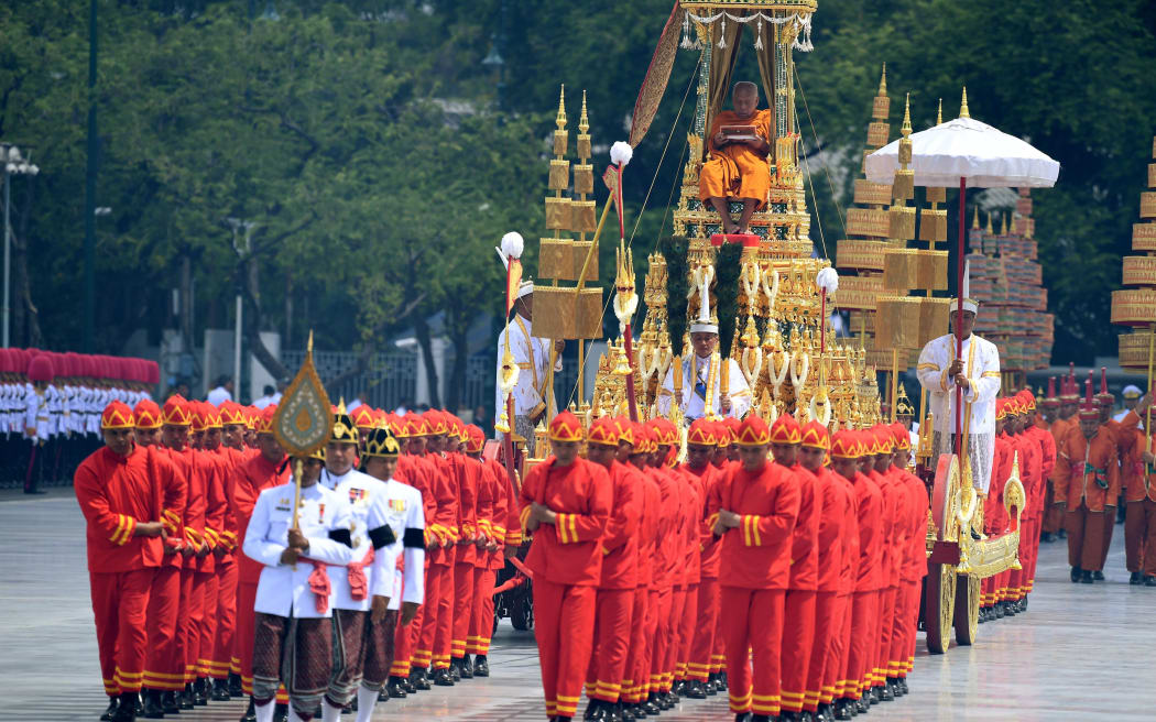 Thai royal military officers pull the Rajarot Noi, carrying the Supreme Patriarch, during the funeral procession for the late Thai king Bhumibol Adulyadej