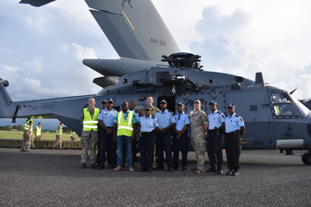 Australian and New Zealand defence force personnel with Solomon Islands Police officers shortly after landing at the Honiara International Airport. March 2019