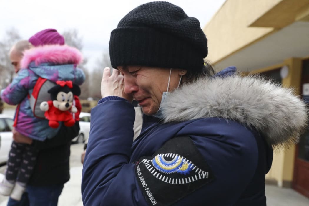 A woman is crying after arriving on a train from Ukraine to the railway station in Przemysl, Poland on February 25, 2022.