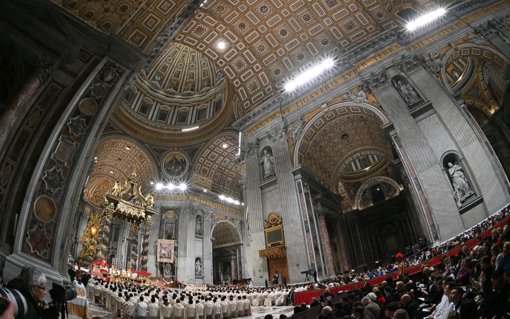 Pope Leo XIV (left) performing the Christmas Eve mass at St Peter's Basilica in the Vatican on 24 December, 2025.