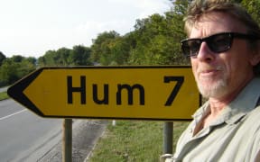 Sound Artist Phil Dadson in tune with a road sign