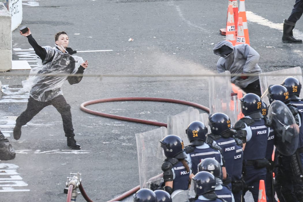 A paving stone is thrown at police by a youth on the Bowen/Lambton Corner