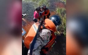 This still from video released by the Bolivian Defense Ministry shows five people being rescued after their plane crashed in an Amazonian jungle. Bolivian Defense Ministry