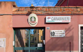 A Carabinieri police station has a sign mounted on the station building in a residential neighborhood on Murano Island in Murano, Venice Province, Veneto, Italy, on November 18, 2025. The scene documents the presence of Italian police and island police service, which is essential to daily life on Murano Island in the Venice Lagoon. (Photo by Michael Nguyen/NurPhoto) (Photo by Michael Nguyen / NurPhoto via AFP)