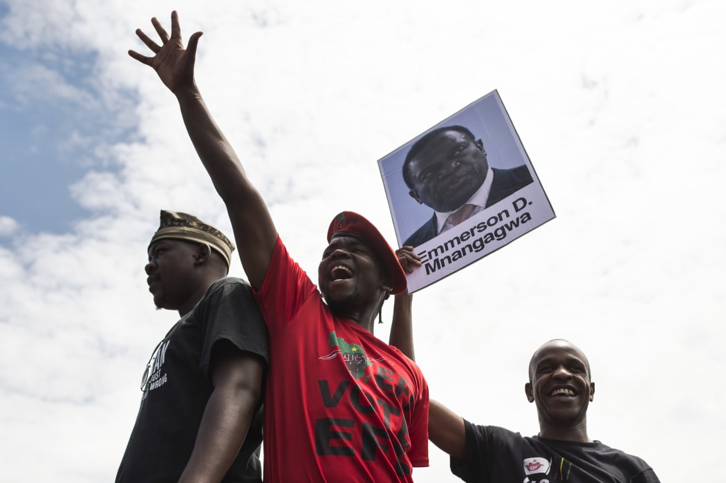 Students in Harare holding a portrait of former vice president Emmerson Mnangagwa, in a demonstration demanding the withdrawal of Grace Mugabe's doctorate.