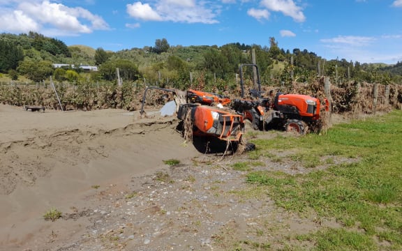 Thick silt and upended tractors lie at the front of Pheasant Farm, Esk Valley, in the wake of Cyclone Gabrielle.