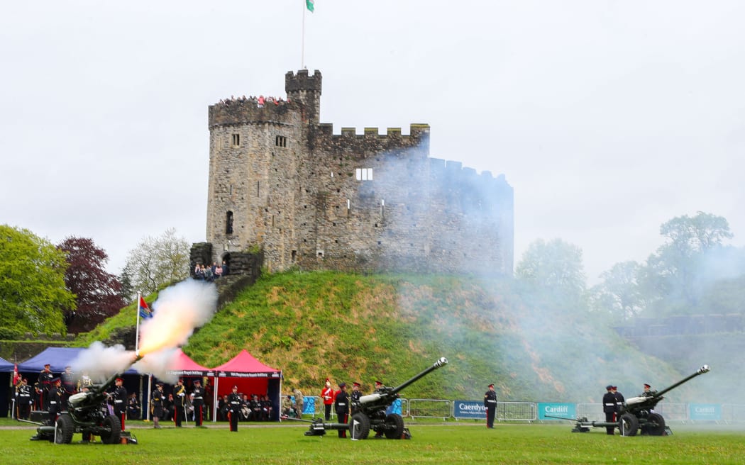 A 21 gun salute takes place after the Coronation Ceremony for the new King and Queen, Britain's King Charles III and Britain's Queen Camilla at Cardiff Castle on May 6, 2023. - The set-piece coronation is the first in Britain in 70 years, and only the second in history to be televised. Charles will be the 40th reigning monarch to be crowned at the central London church since King William I in 1066. Outside the UK, he is also king of 14 other Commonwealth countries, including Australia, Canada and New Zealand. Camilla, his second wife, will be crowned queen alongside him and be known as Queen Camilla after the ceremony. (Photo by Geoff Caddick / AFP)