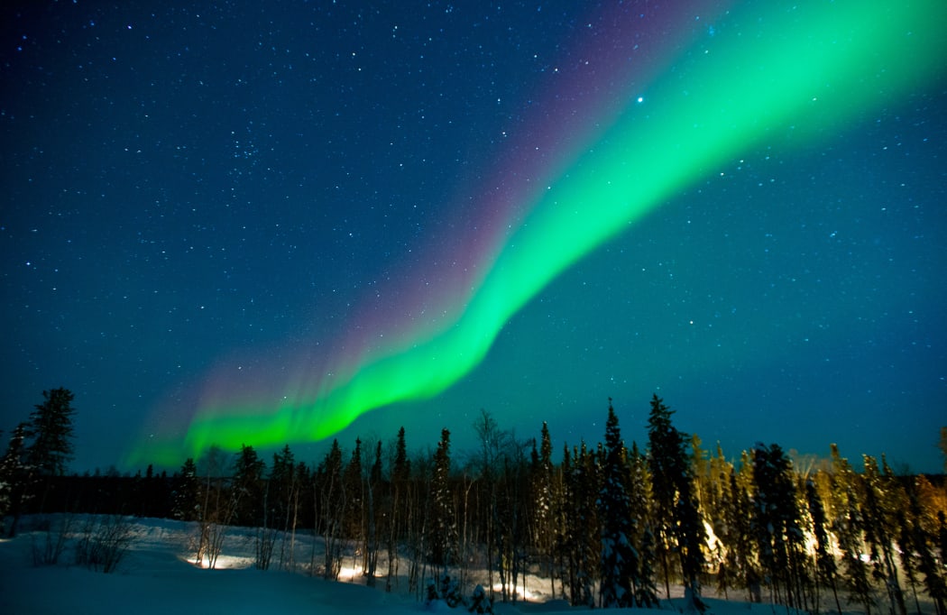 The northern lights stream across the arctic sky near Yellowknife, Northwest Territories in Canada.