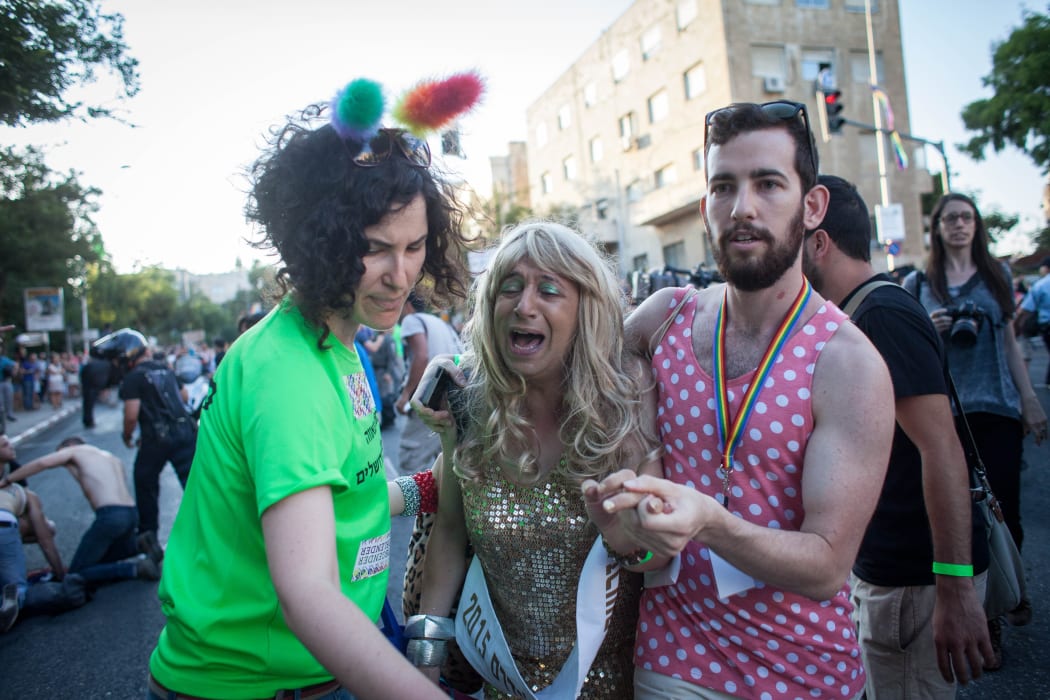 Israelis at the parade react to the stabbings.