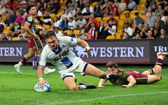Cole Forbes of the Blues scores a try against the Reds.