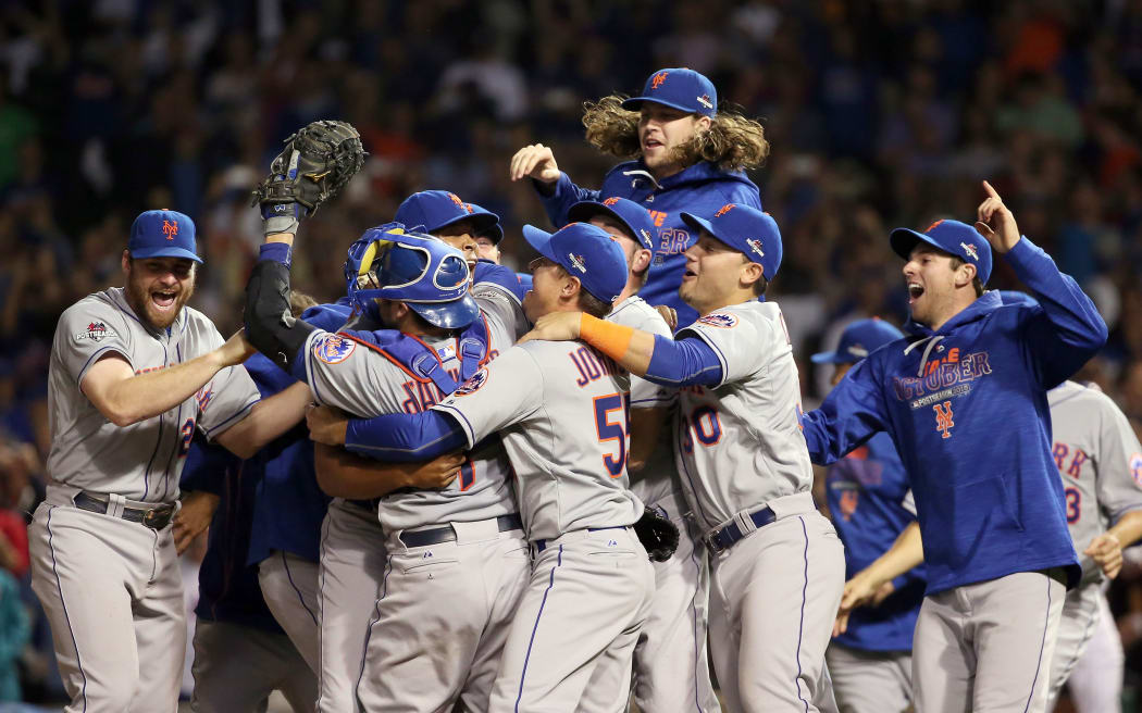 The New York Mets celebrate after defeating the Chicago Cubs in game four of the 2015 MLB National League Championship Series at Wrigley Field on October 21, 2015 in Chicago, Illinois. Jonathan Daniel/Getty Images/AFP