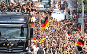 Players and members of the German national football team wave from a truck after their victory over Argentina.