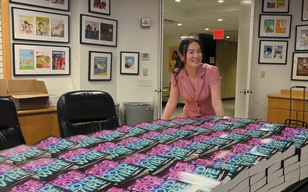 Chloe Gong stands among dozens of her published Cold Wire books in New York.