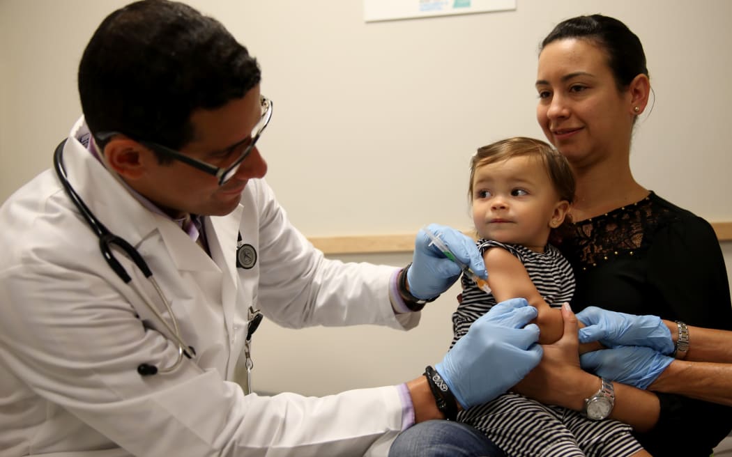 A two-year old being vaccinated against measles.