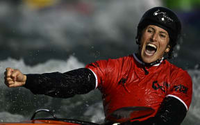 New Zealand's Luuka Jones celebrates after winning the Women's finals Kayak cross, Paris, 2023.