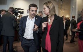 Greek Prime Minister Alexis Tsipras (L) and Federica Mogherini, EU High representative for foreign policy during the family picture at the European heads of state and governments summit at the EU Council headquarters in Brussels, Belgium.
