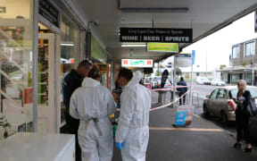 Police examine the scene after a stabbing at Grey Lynn supprette, Hylite Dairy.