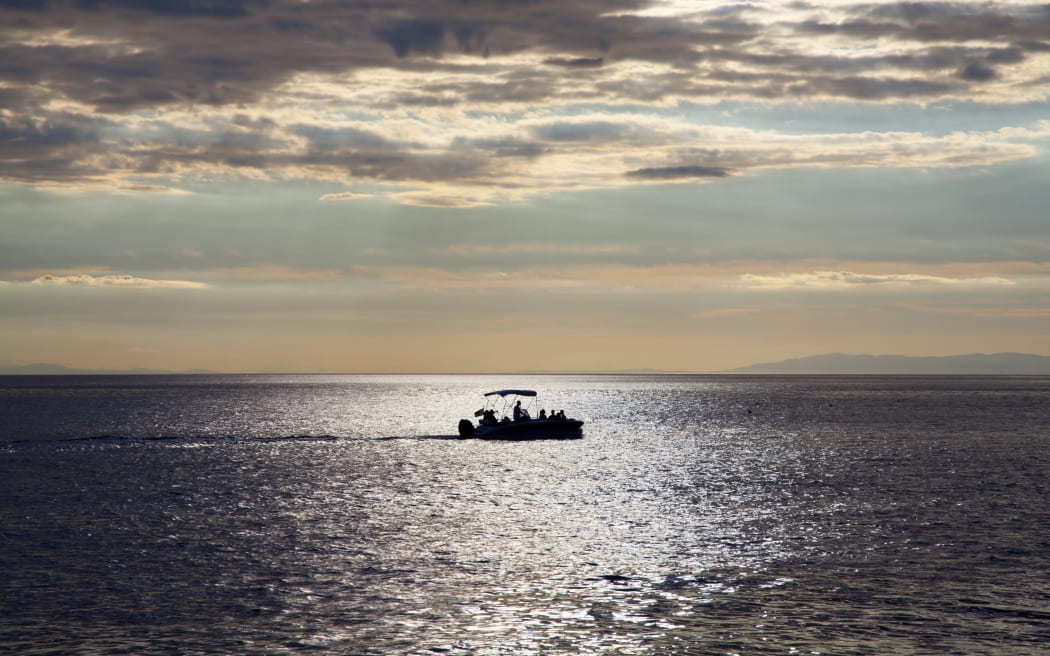 Fishing boat alone in sea.